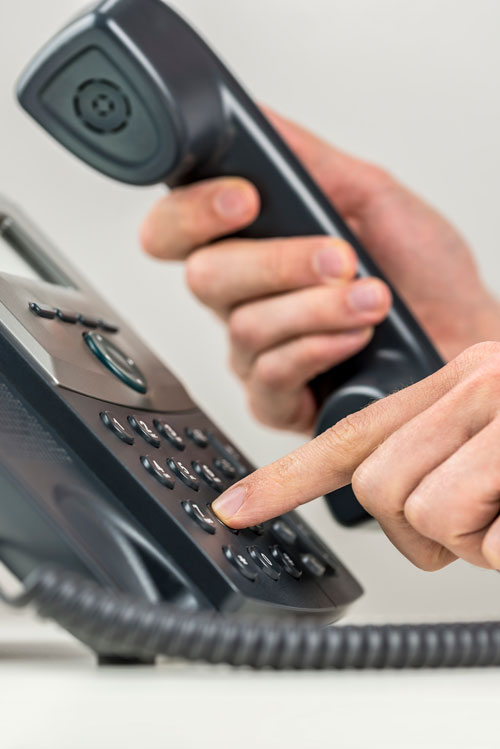 lady pushing buttons on a telephone